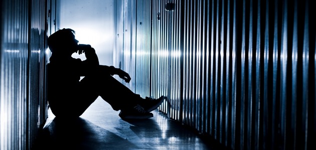 garçon assis dans le noir